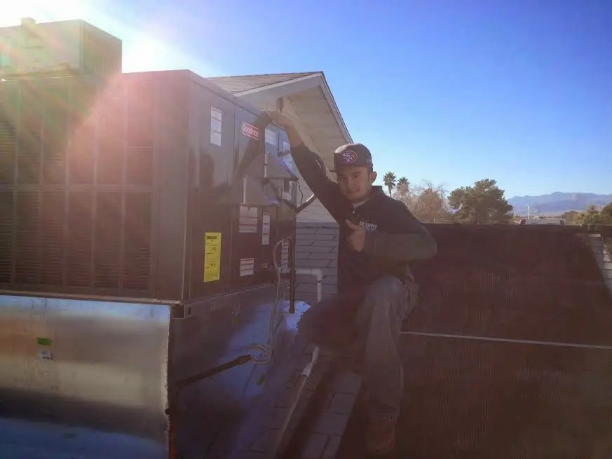 HVAC technician performing Heat Pump Repair on a rooftop unit in Lake Murray of Richland